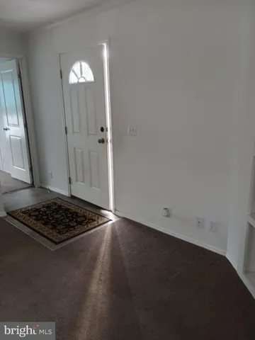 a view of a utility room with wooden floor and a sink