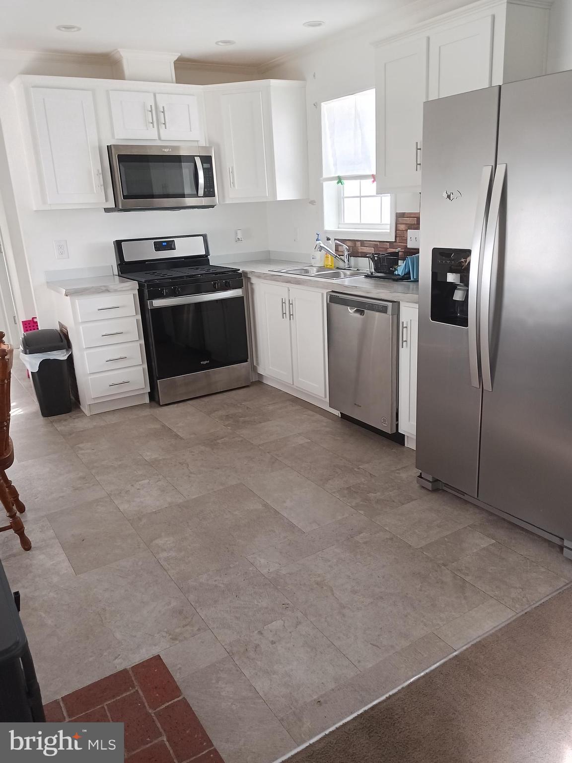 1405 Farrell Avenue, Unit 325 Cherry Hill, NJ 08002 - Photo 6 of 15 a kitchen with stainless steel appliances granite countertop a stove a sink and a refrigerator