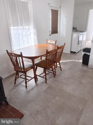 a view of a dining room with furniture and a window