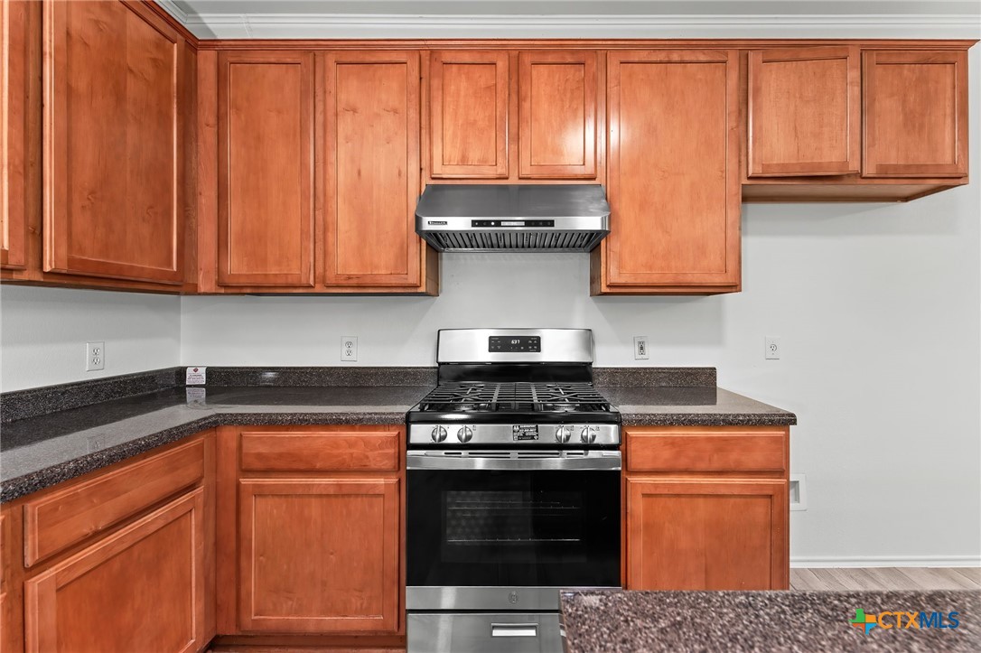 6700 Tulloch Way Austin, TX 78754 - Photo 14 of 41 a stove top oven sitting inside of a kitchen