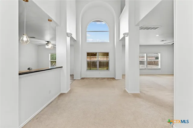 a view of an empty room with a ceiling fan