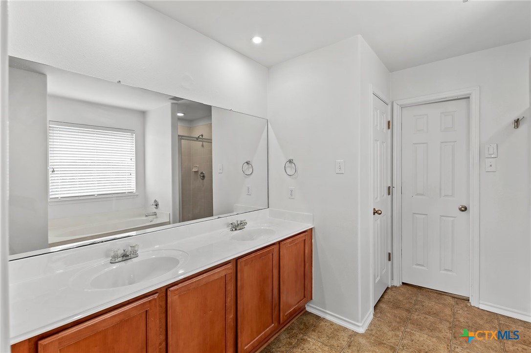 6700 Tulloch Way Austin, TX 78754 - Photo 27 of 41 a bathroom with a sink a mirror and a bathtub