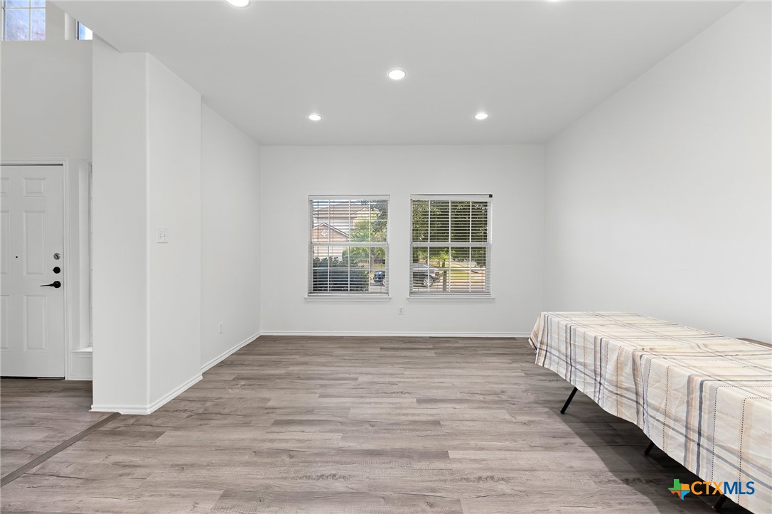 6700 Tulloch Way Austin, TX 78754 - Photo 10 of 41 a view of an empty room with wooden floor and a window