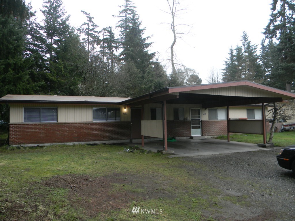 513 Roe Street Steilacoom, WA 98388 - Photo 1 of 14 a front view of a house with a yard and garage