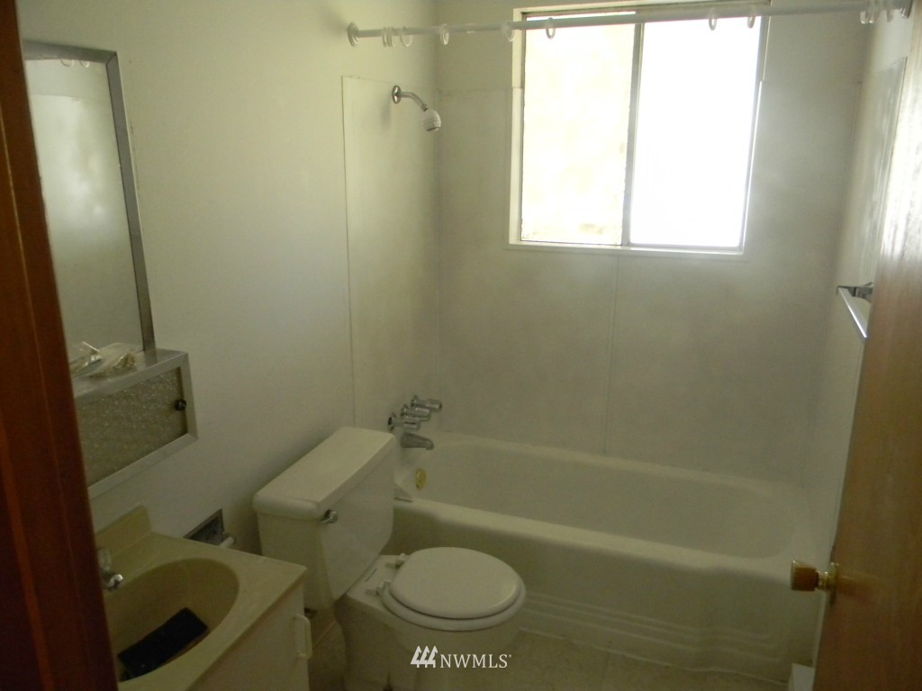 513 Roe Street Steilacoom, WA 98388 - Photo 12 of 14 a bathroom with a toilet and a shower