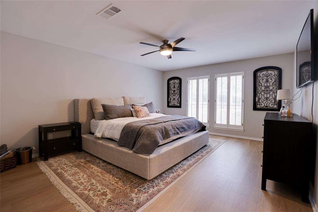 54 Legend Road Benbrook, TX 76132 - Photo 11 of 23 a bedroom with a large bed and a chandelier