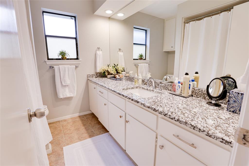 54 Legend Road Benbrook, TX 76132 - Photo 16 of 23 a bathroom with a double vanity sink window and shower