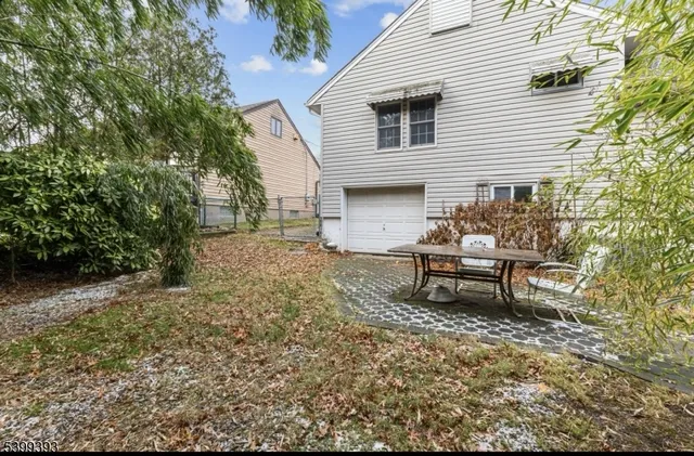 a view of a house with a yard and sitting area