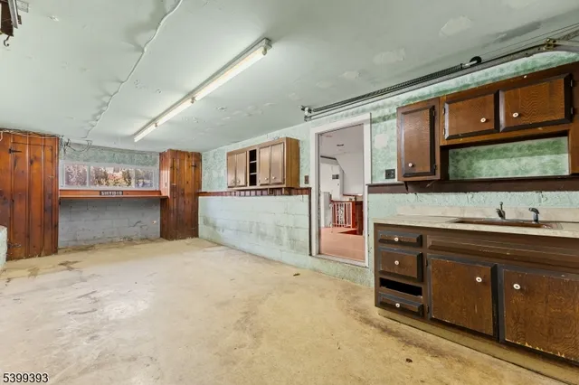 a large kitchen with stainless steel appliances granite countertop a sink and cabinets