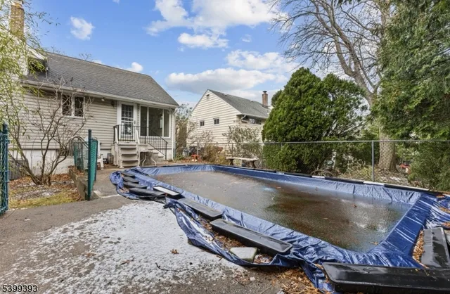 a swimming pool with outdoor seating and yard
