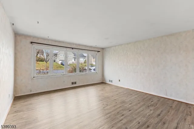 an empty room with large window