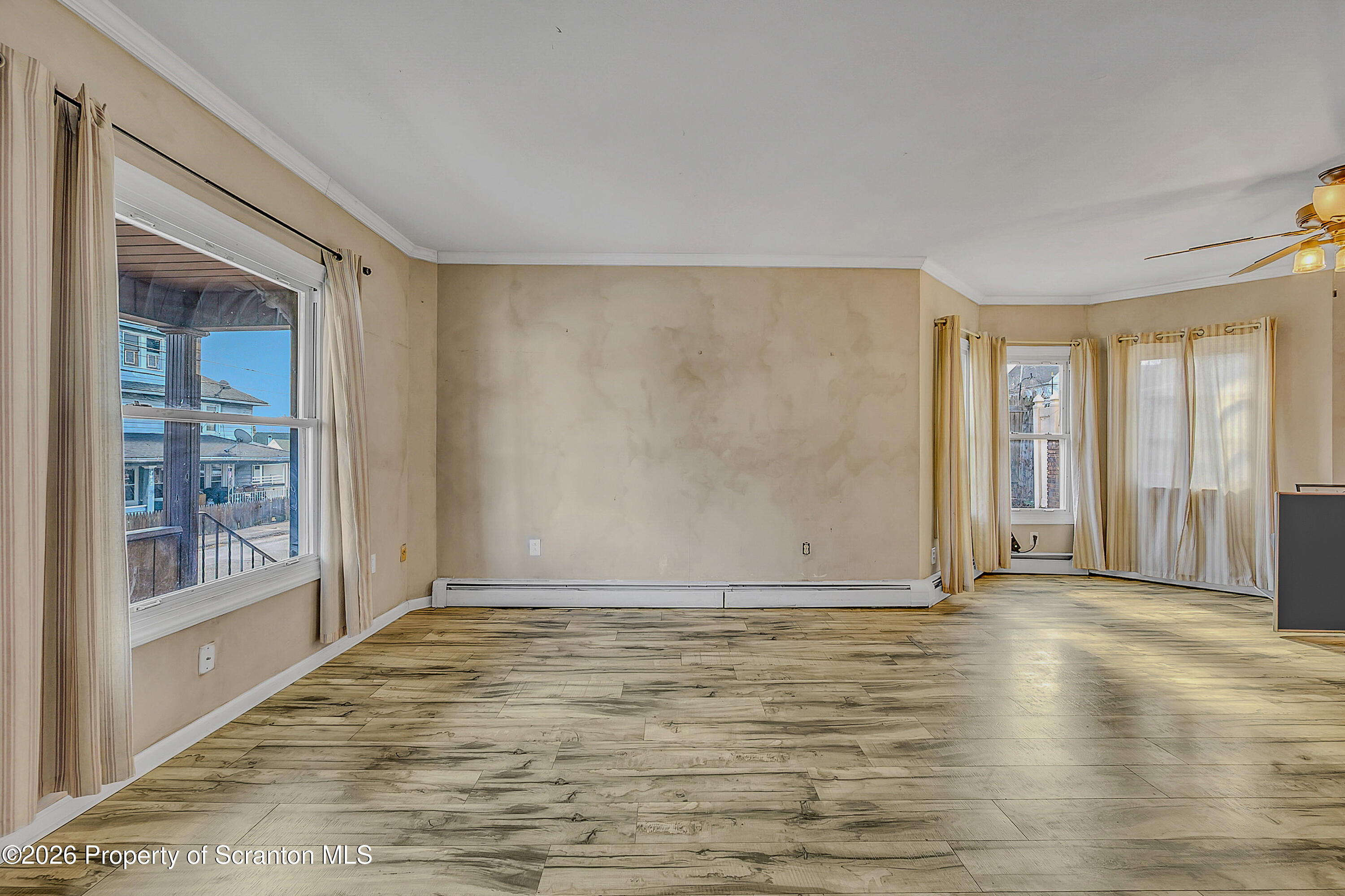 929 Ridge Avenue Scranton, PA 18510 - Photo 12 of 33 a view of an empty room with wooden floor and a window
