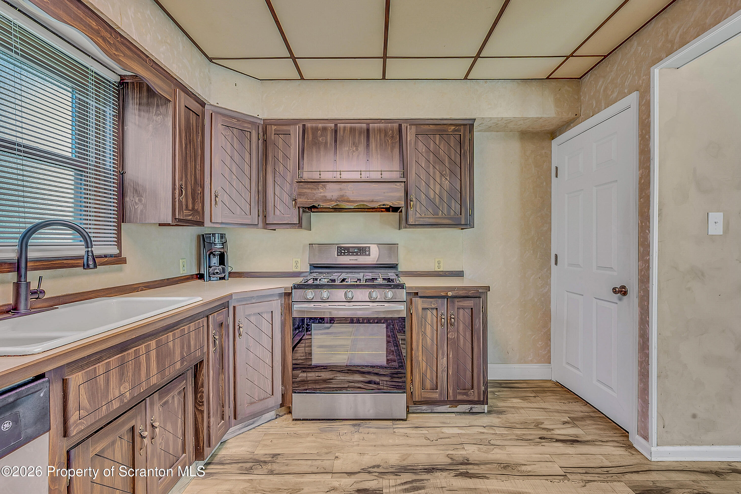 929 Ridge Avenue Scranton, PA 18510 - Photo 16 of 33 a kitchen with stainless steel appliances granite countertop a stove a sink and a refrigerator