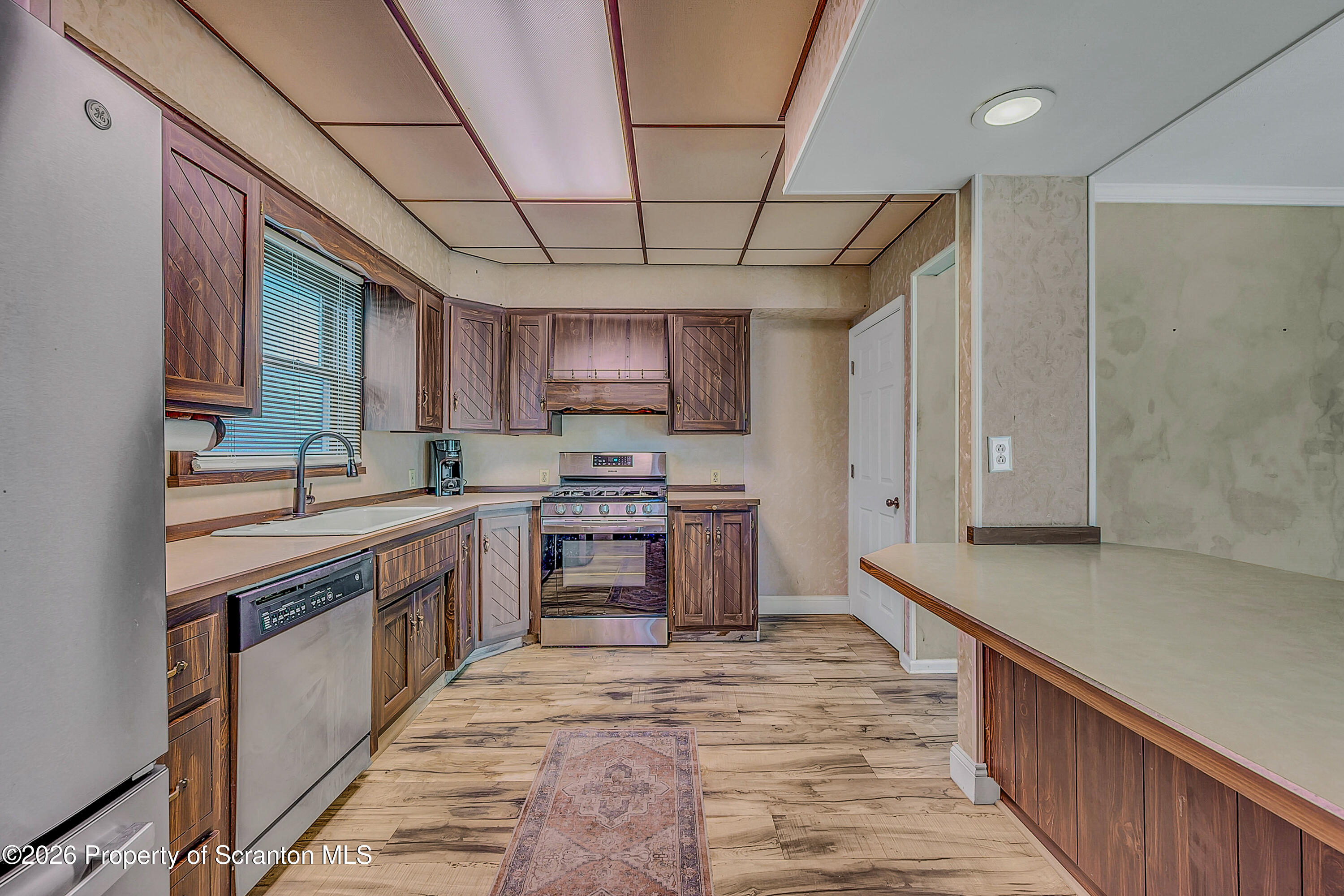 929 Ridge Avenue Scranton, PA 18510 - Photo 19 of 33 a kitchen with stainless steel appliances granite countertop a sink stove and refrigerator
