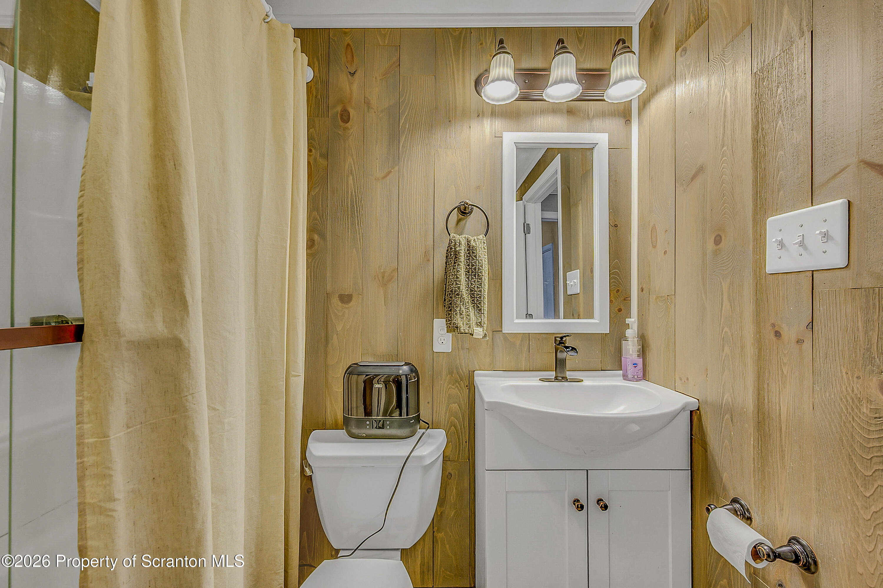 929 Ridge Avenue Scranton, PA 18510 - Photo 28 of 33 a bathroom with a sink a mirror a toilet and a window
