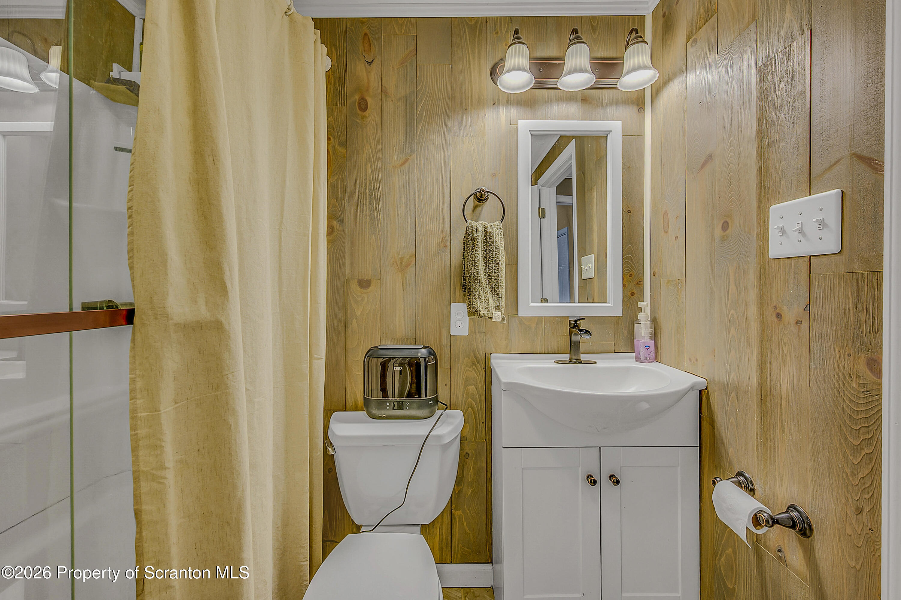 929 Ridge Avenue Scranton, PA 18510 - Photo 30 of 33 a bathroom with a toilet sink and mirror