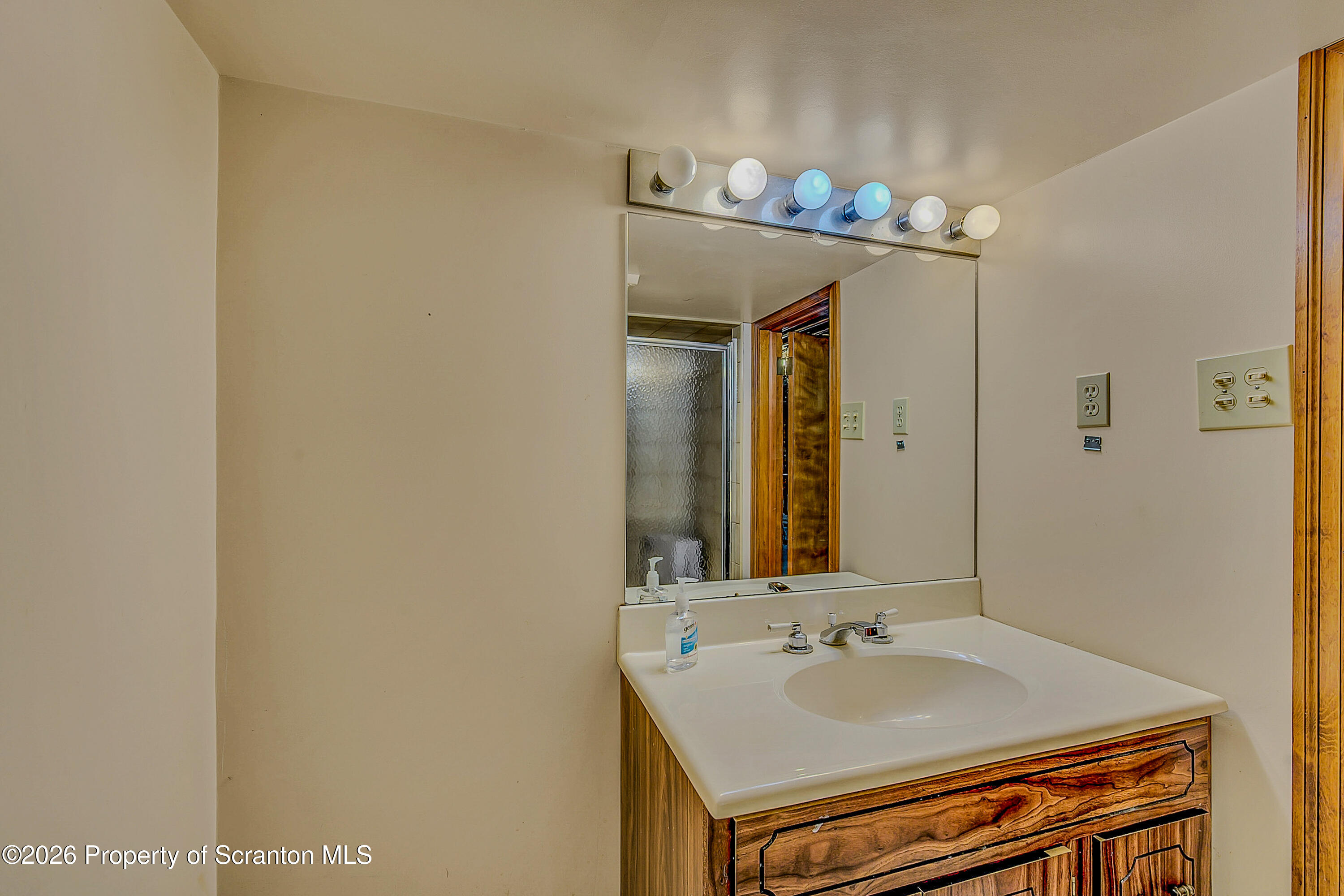 929 Ridge Avenue Scranton, PA 18510 - Photo 33 of 33 a bathroom with a sink and a mirror