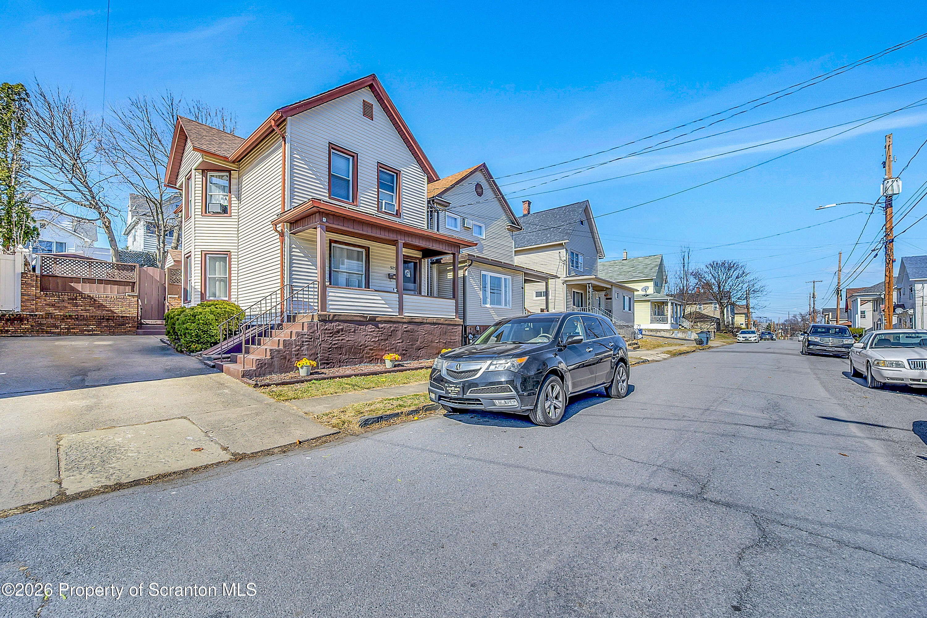 929 Ridge Avenue Scranton, PA 18510 - Photo 4 of 33 a car parked in front of a white house