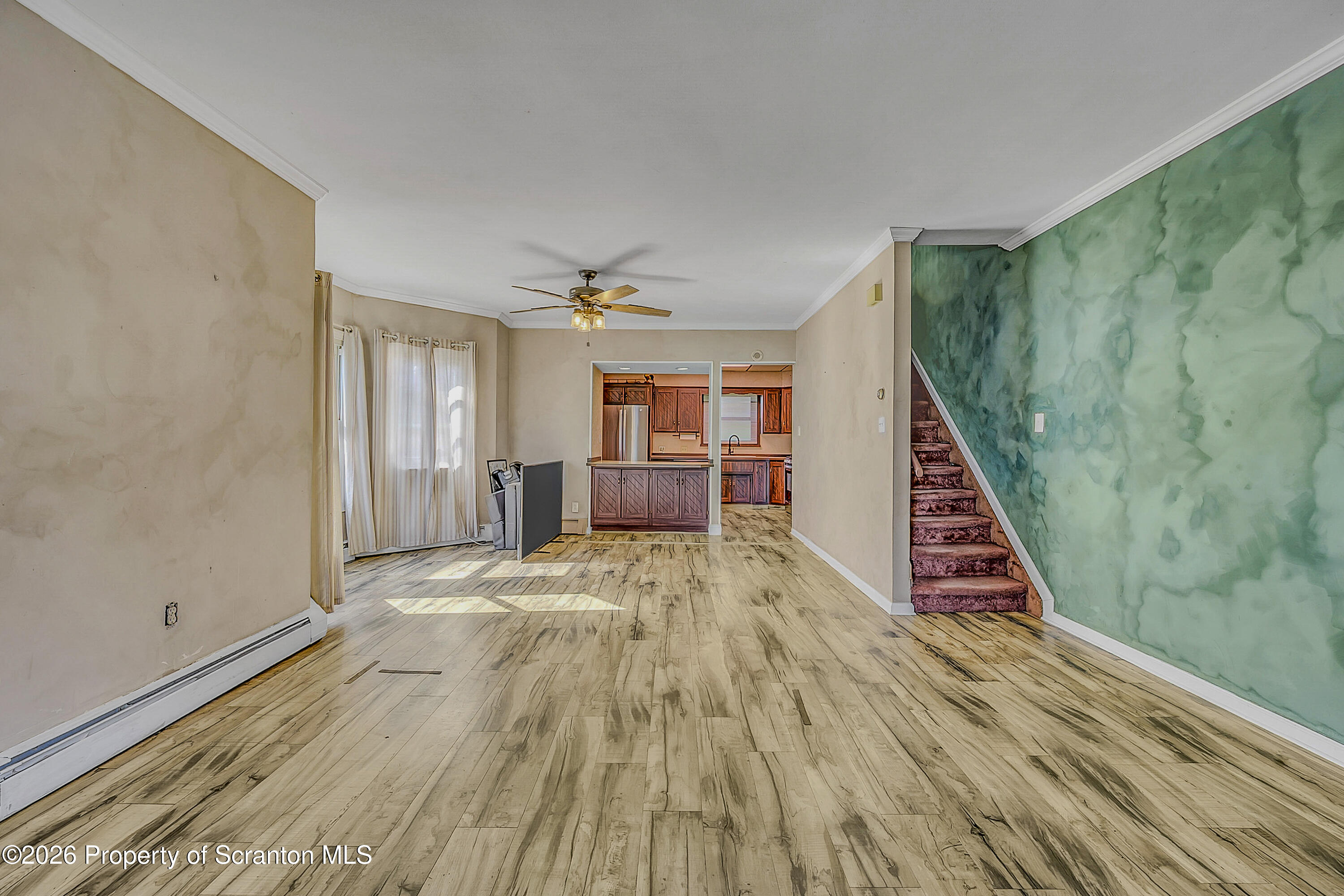 929 Ridge Avenue Scranton, PA 18510 - Photo 10 of 33 a view of a bedroom with wooden floor and stairs