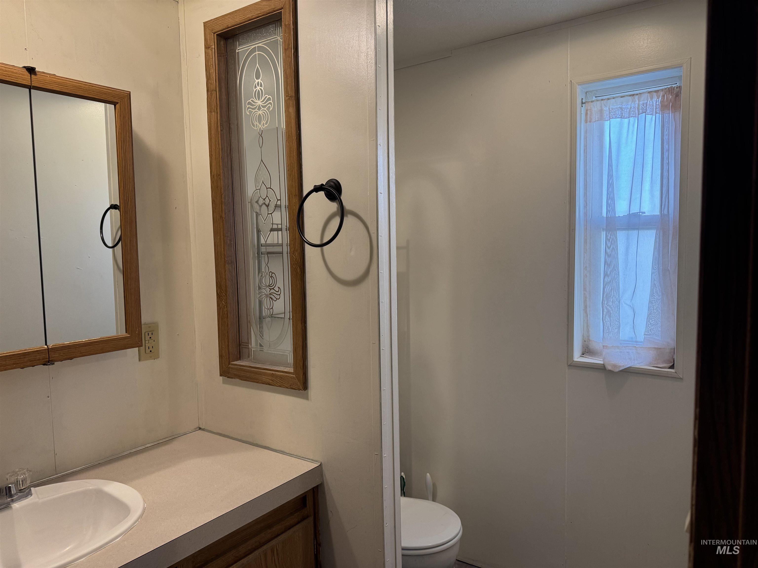198 South Hills Road, Unit 83 Twin Falls, ID 83301 - Photo 16 of 21 Half bathroom featuring vanity and toilet