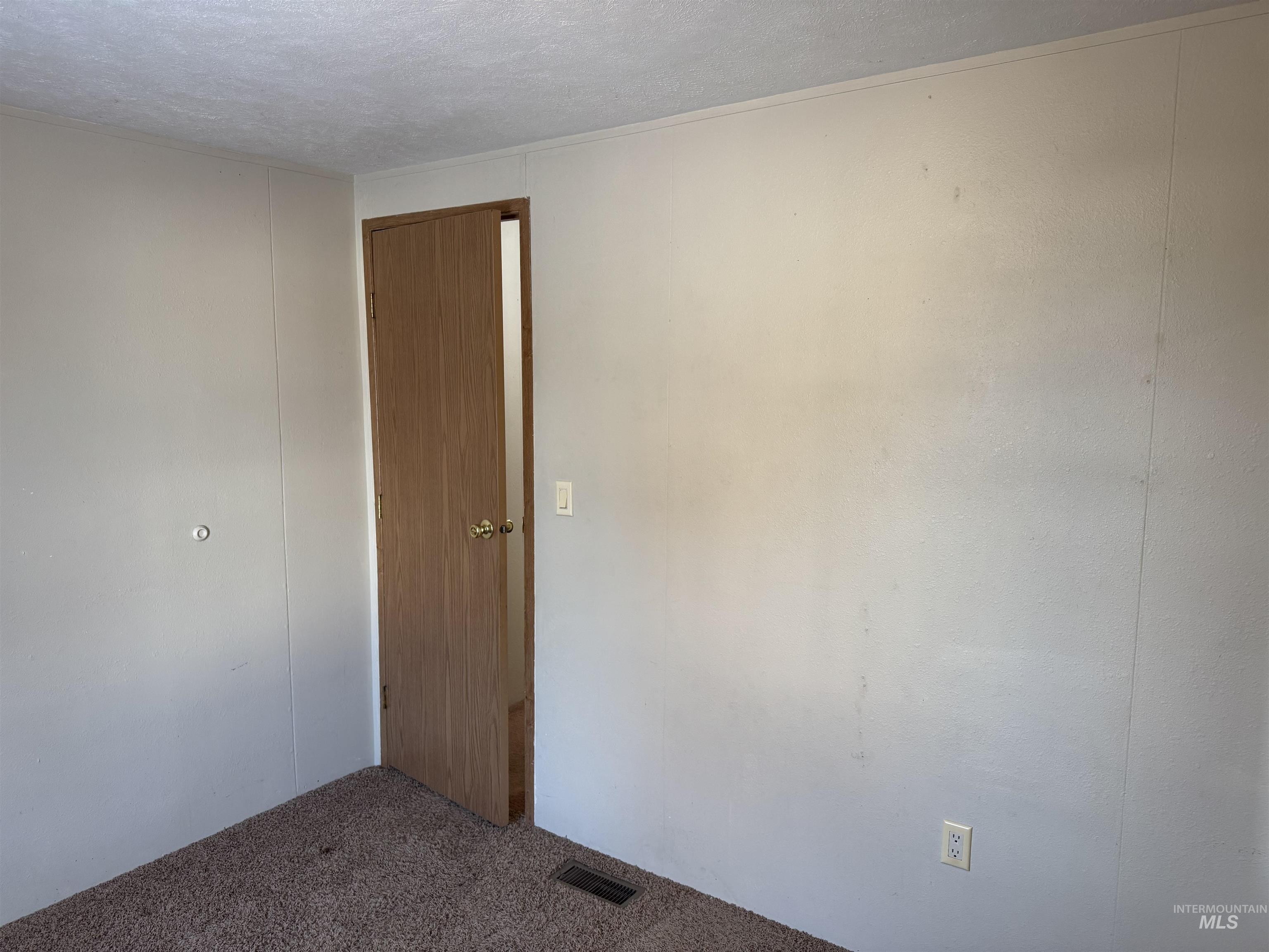 198 South Hills Road, Unit 83 Twin Falls, ID 83301 - Photo 19 of 21 Carpeted spare room with a textured ceiling