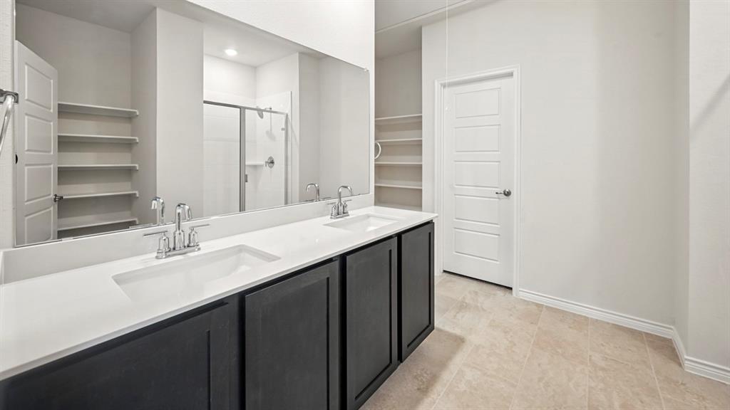 412 Carthage Street Caddo Mills, TX 75135 - Photo 23 of 32 Dual vanity featuring undermount sinks, chrome faucets, and a white countertop