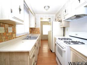 1726 Ramar Road Bullhead City, AZ 86442 - Photo 2 of 20 a kitchen with a stove and a sink