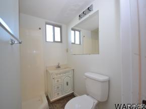 1726 Ramar Road Bullhead City, AZ 86442 - Photo 7 of 20 a white toilet sitting next to a bathroom sink