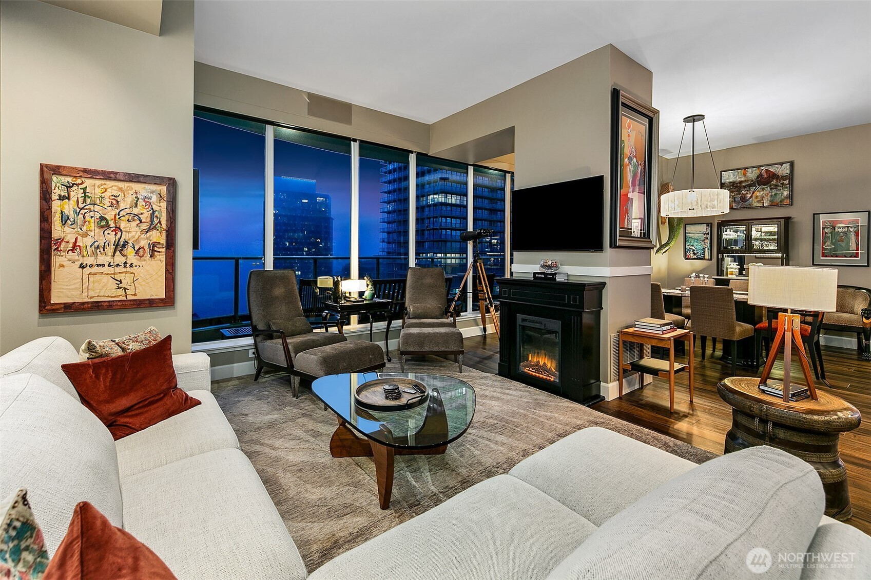 1920 4th Avenue, Unit 2802 Seattle, WA 98101 - Photo 11 of 40 a living room with furniture a flat screen tv and a fireplace