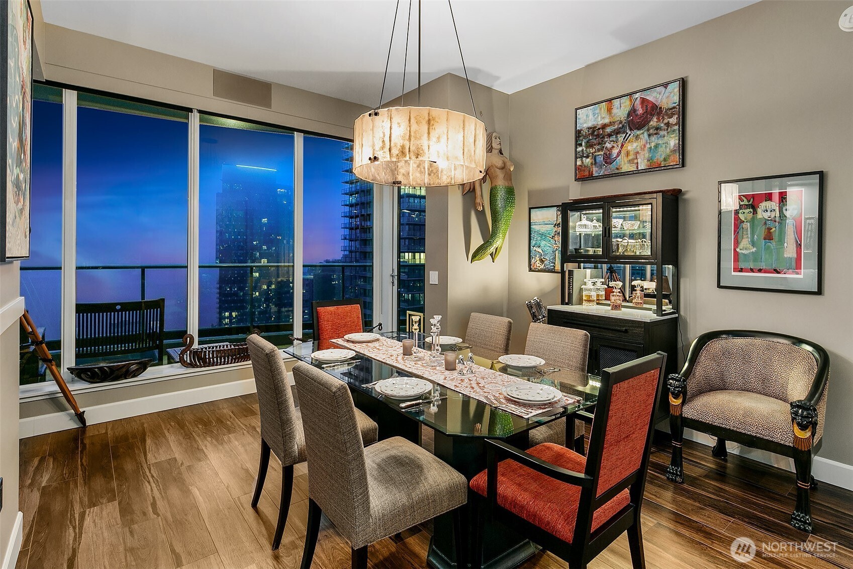 1920 4th Avenue, Unit 2802 Seattle, WA 98101 - Photo 12 of 40 a dining room with furniture a chandelier and window