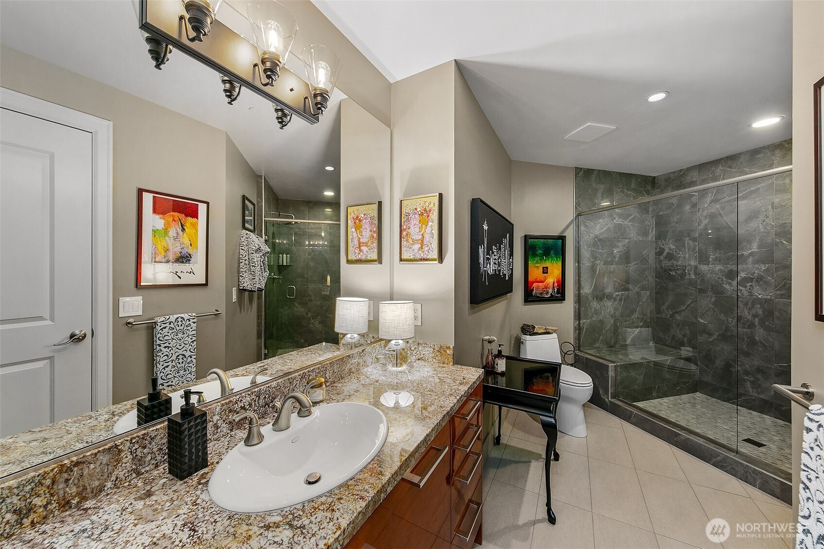 1920 4th Avenue, Unit 2802 Seattle, WA 98101 - Photo 23 of 40 a bathroom with a sink and a mirror