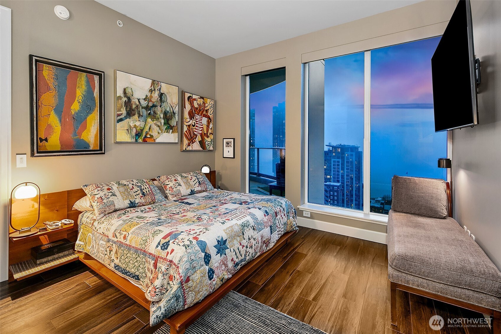 1920 4th Avenue, Unit 2802 Seattle, WA 98101 - Photo 25 of 40 a bedroom with a bed and flat screen tv