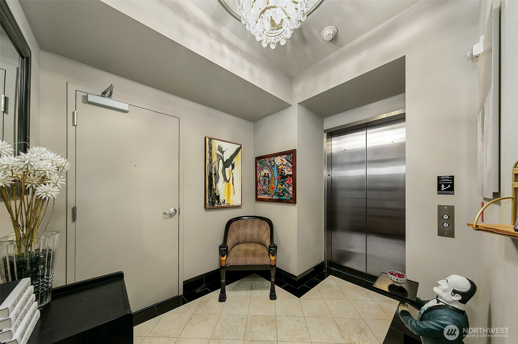 1920 4th Avenue, Unit 2802 Seattle, WA 98101 - Photo 31 of 40 a view of a hallway with paintings on the wall