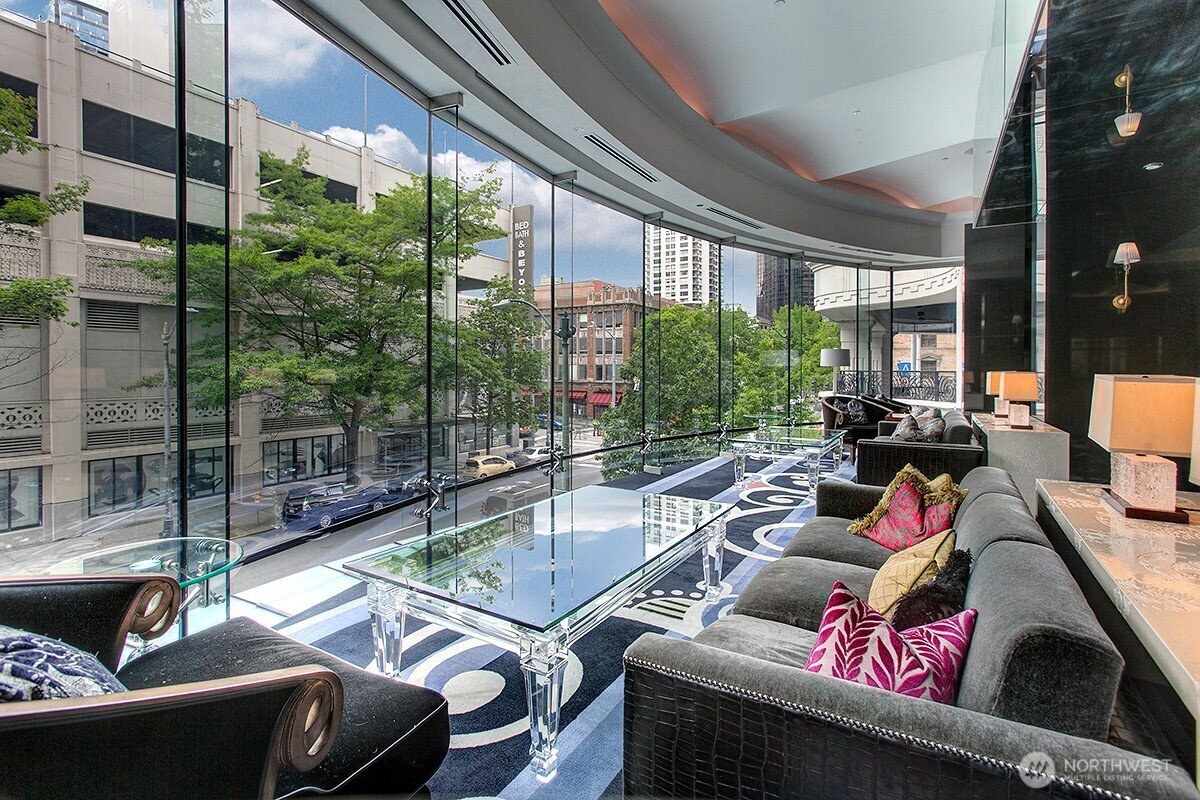 1920 4th Avenue, Unit 2802 Seattle, WA 98101 - Photo 36 of 40 a living room with furniture and a floor to ceiling window