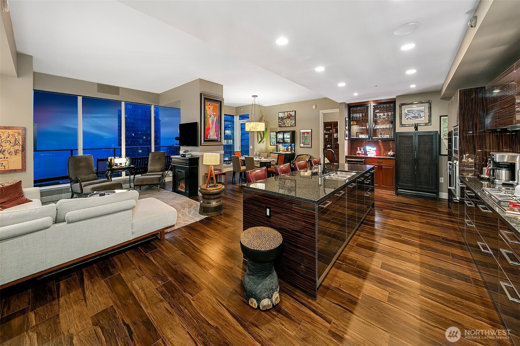 1920 4th Avenue, Unit 2802 Seattle, WA 98101 - Photo 8 of 40 a living room with furniture a wooden floor and kitchen view