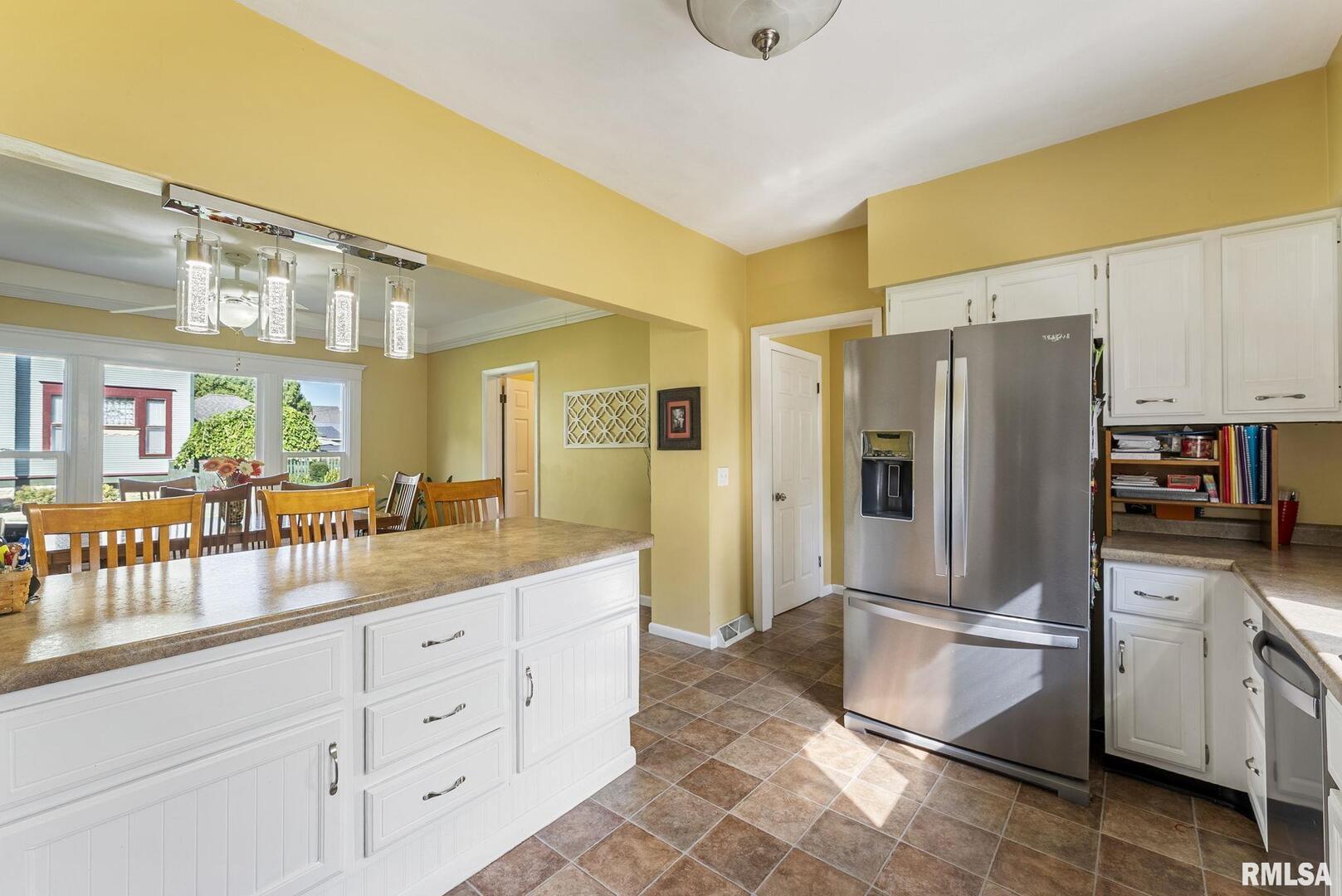 109 West 6th Street Wilton, IA 52778 - Photo 17 of 40 a kitchen with cabinets and stainless steel appliances