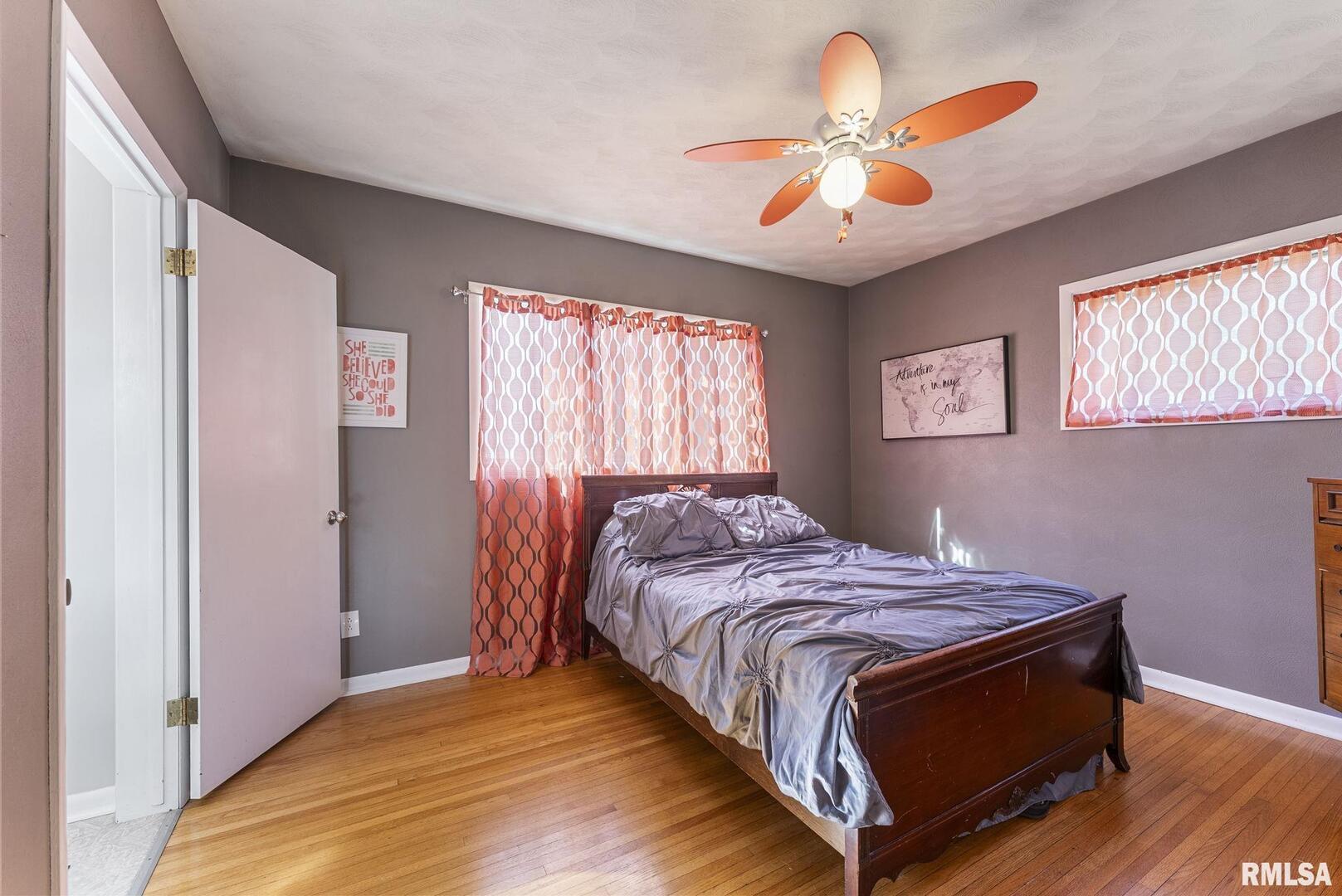 109 West 6th Street Wilton, IA 52778 - Photo 18 of 40 a bed sitting in a bedroom next to a window