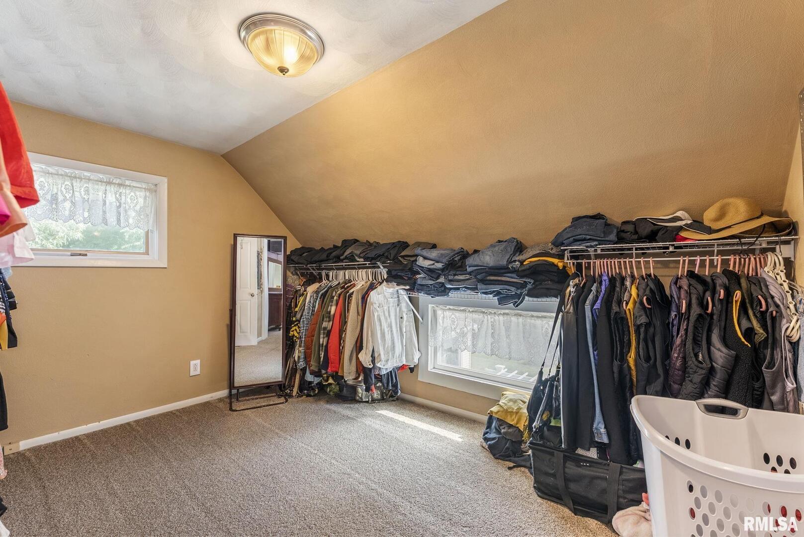 109 West 6th Street Wilton, IA 52778 - Photo 23 of 40 a view of walk in closet with clothes and shoes
