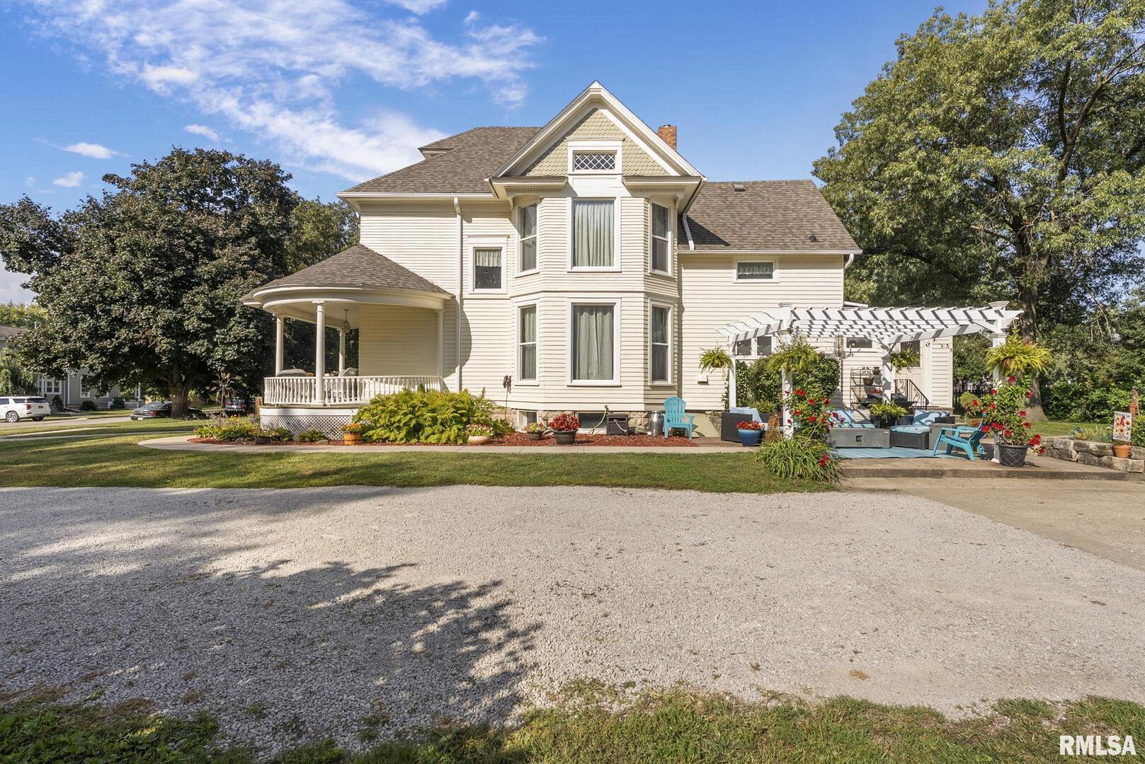 109 West 6th Street Wilton, IA 52778 - Photo 30 of 40 a front view of a house with a yard and garage