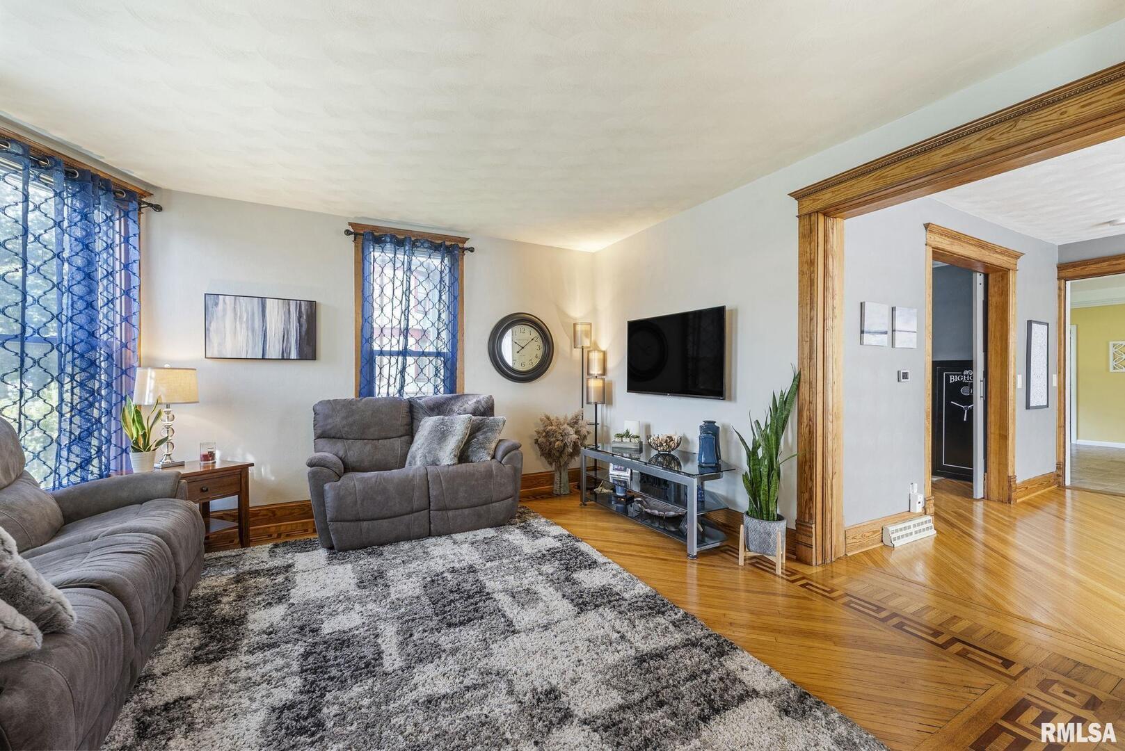 109 West 6th Street Wilton, IA 52778 - Photo 5 of 40 a living room with furniture and a flat screen tv