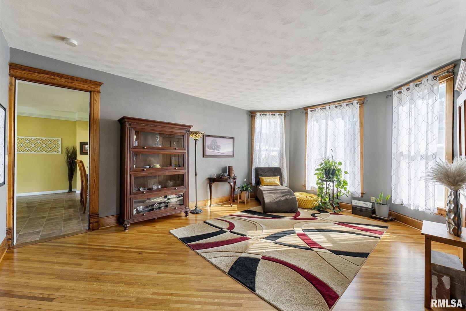 109 West 6th Street Wilton, IA 52778 - Photo 8 of 40 a living room with furniture and large windows