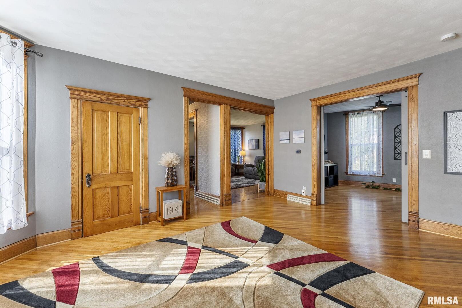 109 West 6th Street Wilton, IA 52778 - Photo 10 of 40 a living room with furniture and wooden floor