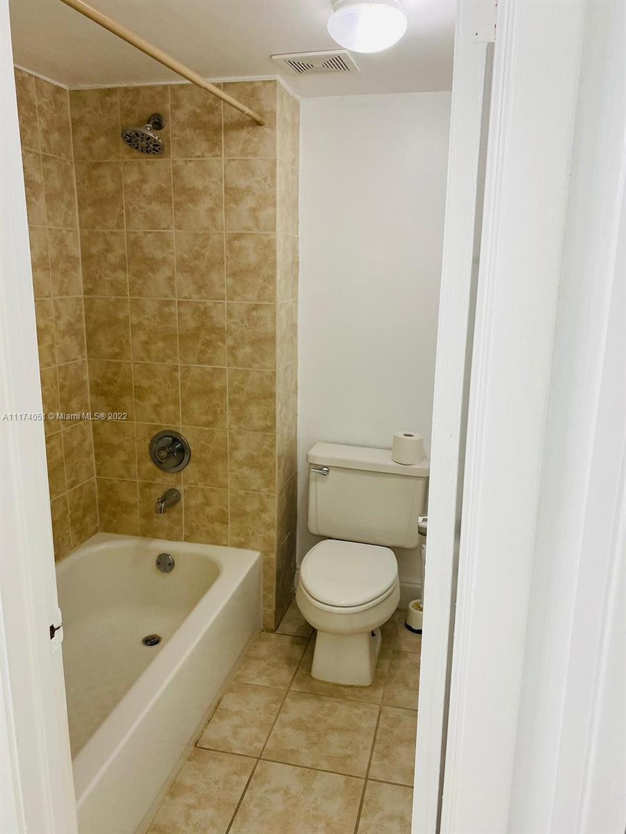 380 Racquet Club Road, Unit 103 Weston, FL 33326 - Photo 13 of 25 a bathroom with a toilet and a shower