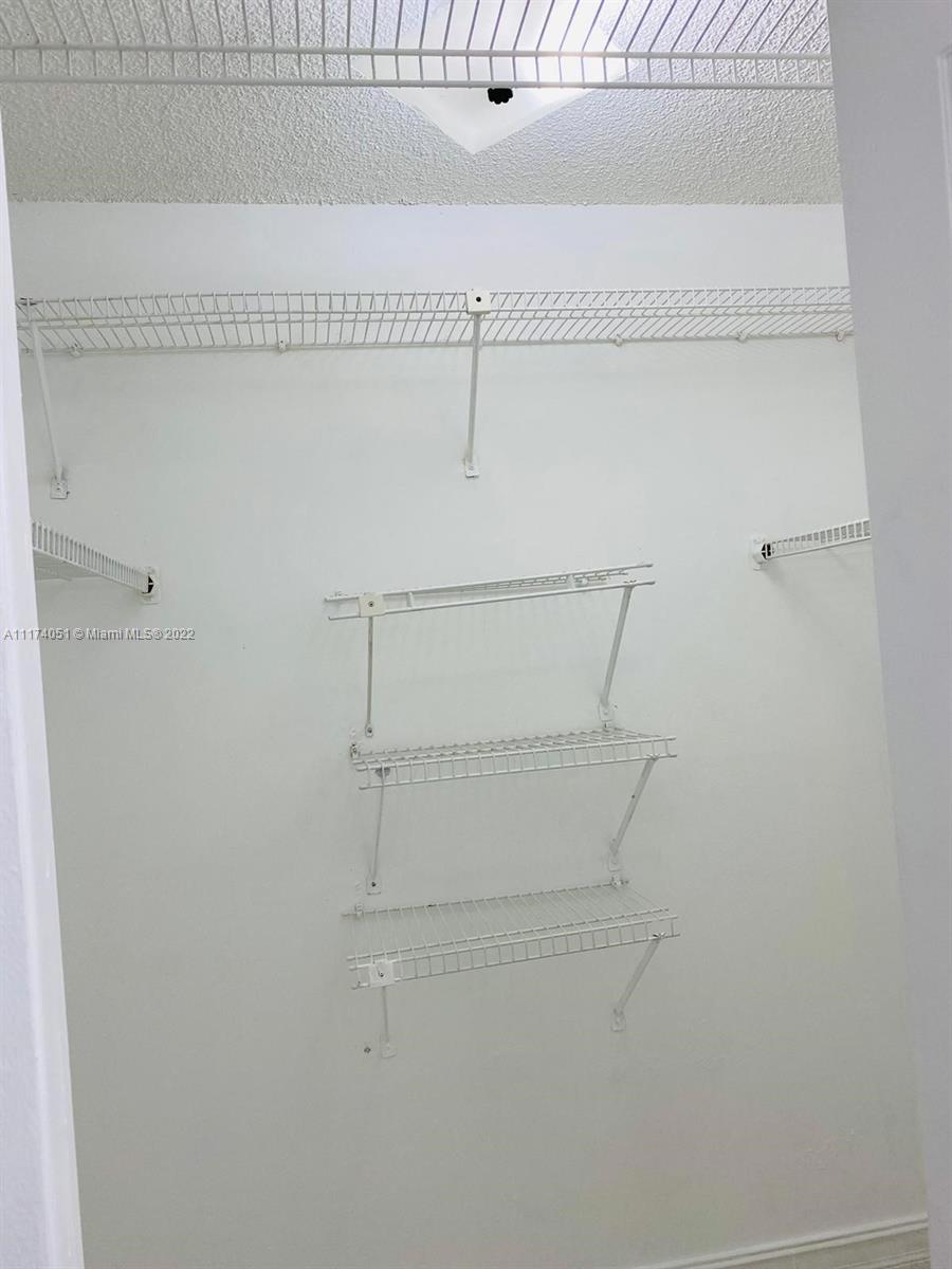 380 Racquet Club Road, Unit 103 Weston, FL 33326 - Photo 14 of 25 a view of small space with racks on the wall