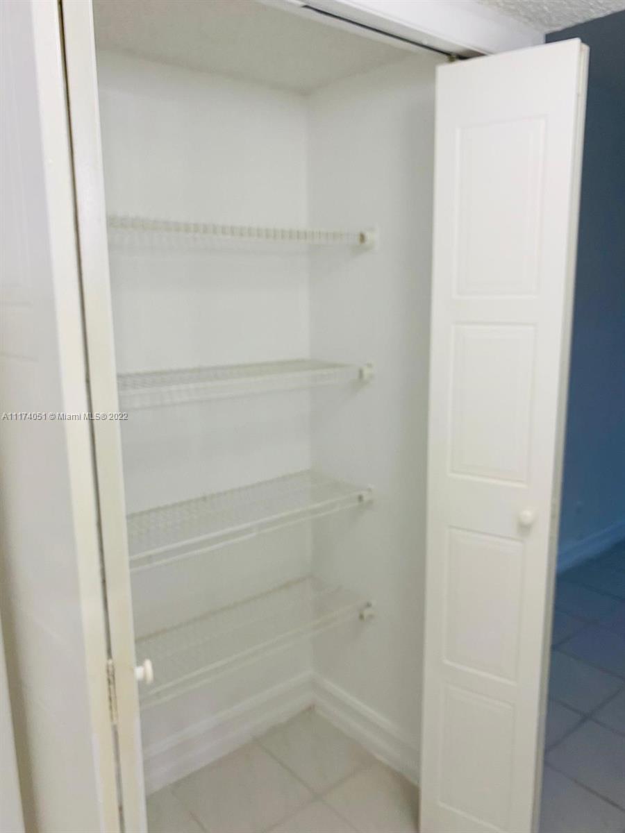 380 Racquet Club Road, Unit 103 Weston, FL 33326 - Photo 15 of 25 a view of walk in closet with empty racks