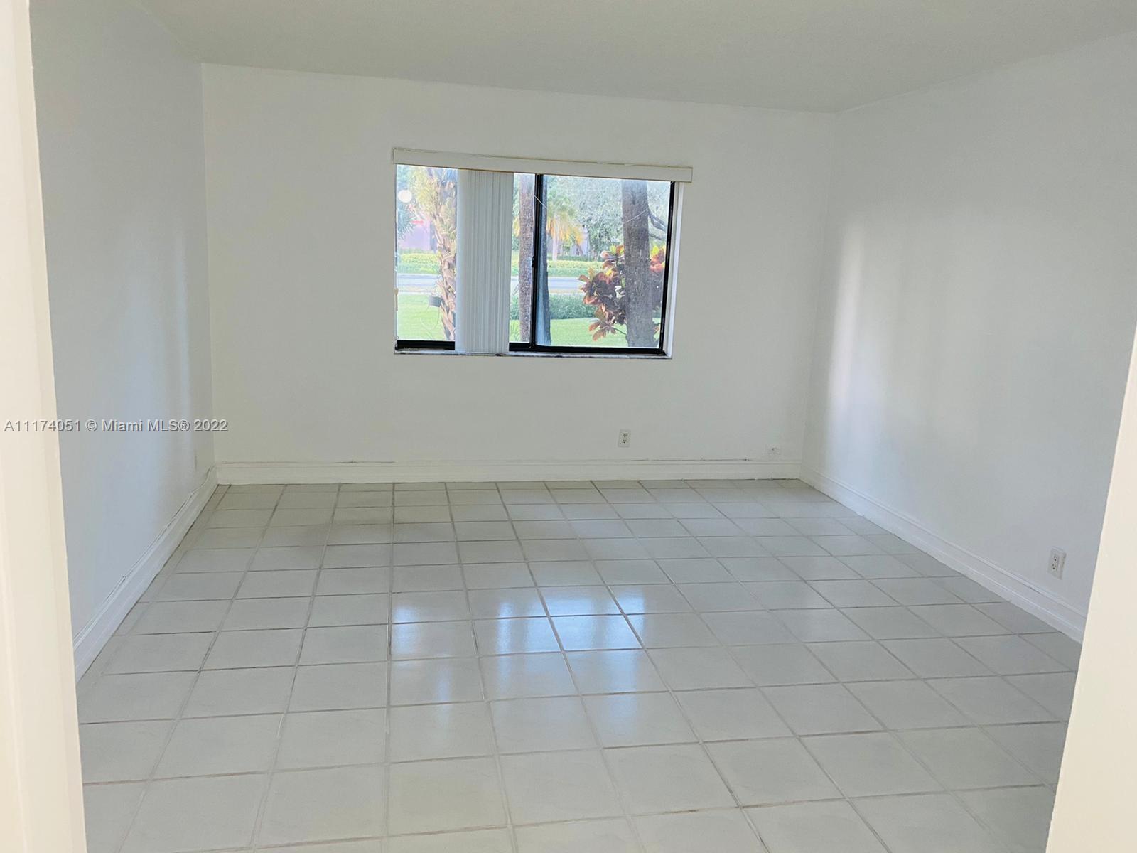 380 Racquet Club Road, Unit 103 Weston, FL 33326 - Photo 17 of 25 an empty room with windows