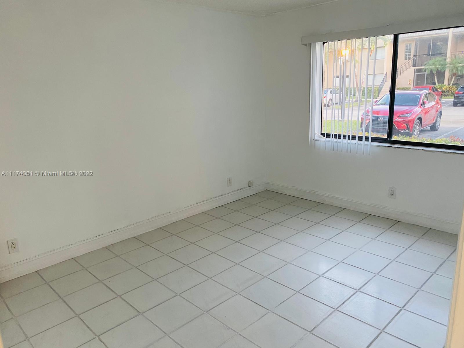 380 Racquet Club Road, Unit 103 Weston, FL 33326 - Photo 22 of 25 an empty room with windows