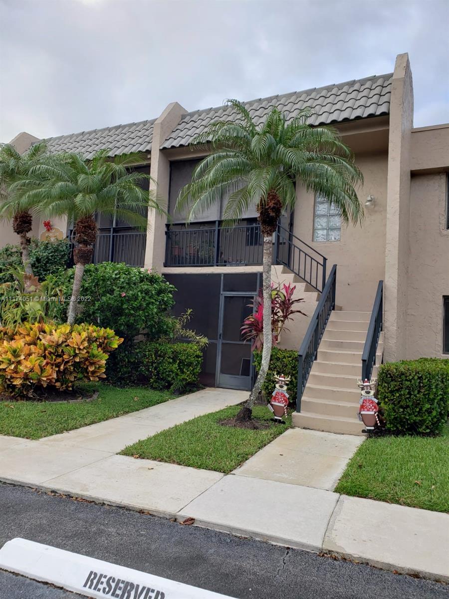 380 Racquet Club Road, Unit 103 Weston, FL 33326 - Photo 3 of 25 a view of a porch with furniture and garden