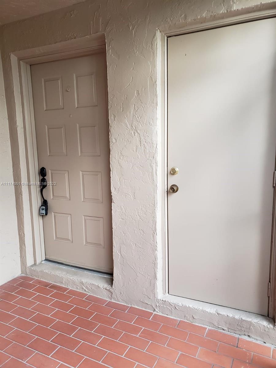 380 Racquet Club Road, Unit 103 Weston, FL 33326 - Photo 6 of 25 a view of a small space with wooden floor and closet