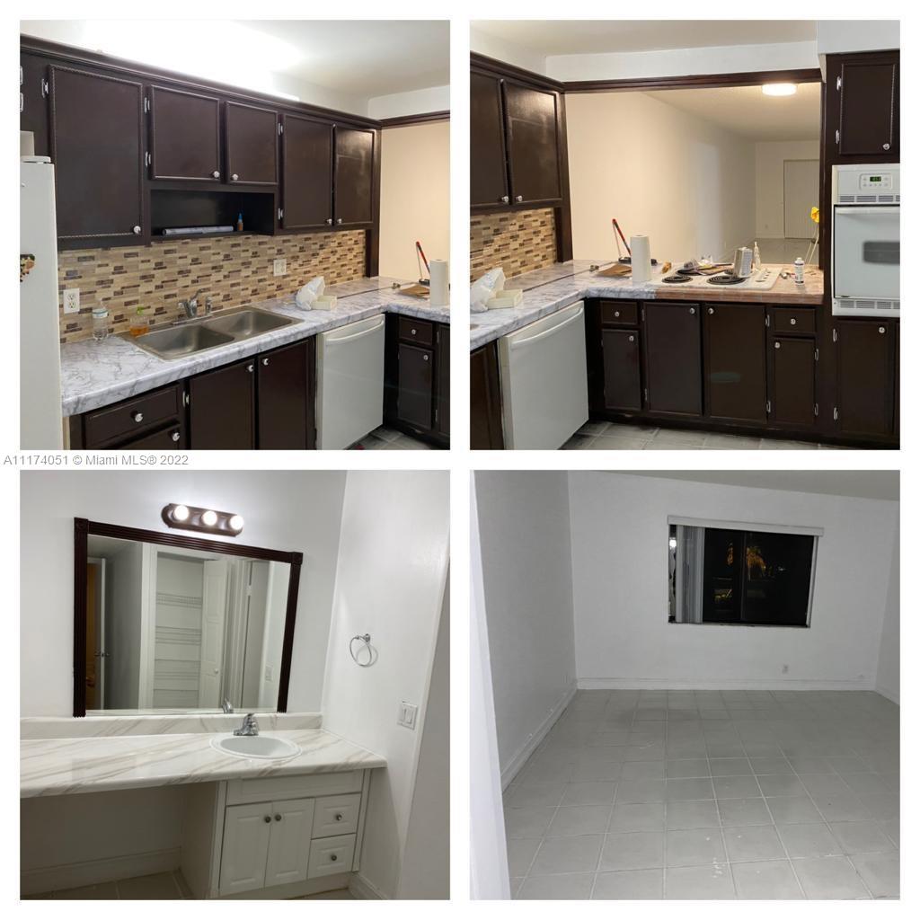 380 Racquet Club Road, Unit 103 Weston, FL 33326 - Photo 8 of 25 a kitchen with stainless steel appliances kitchen island granite countertop a stove a sink and a microwave
